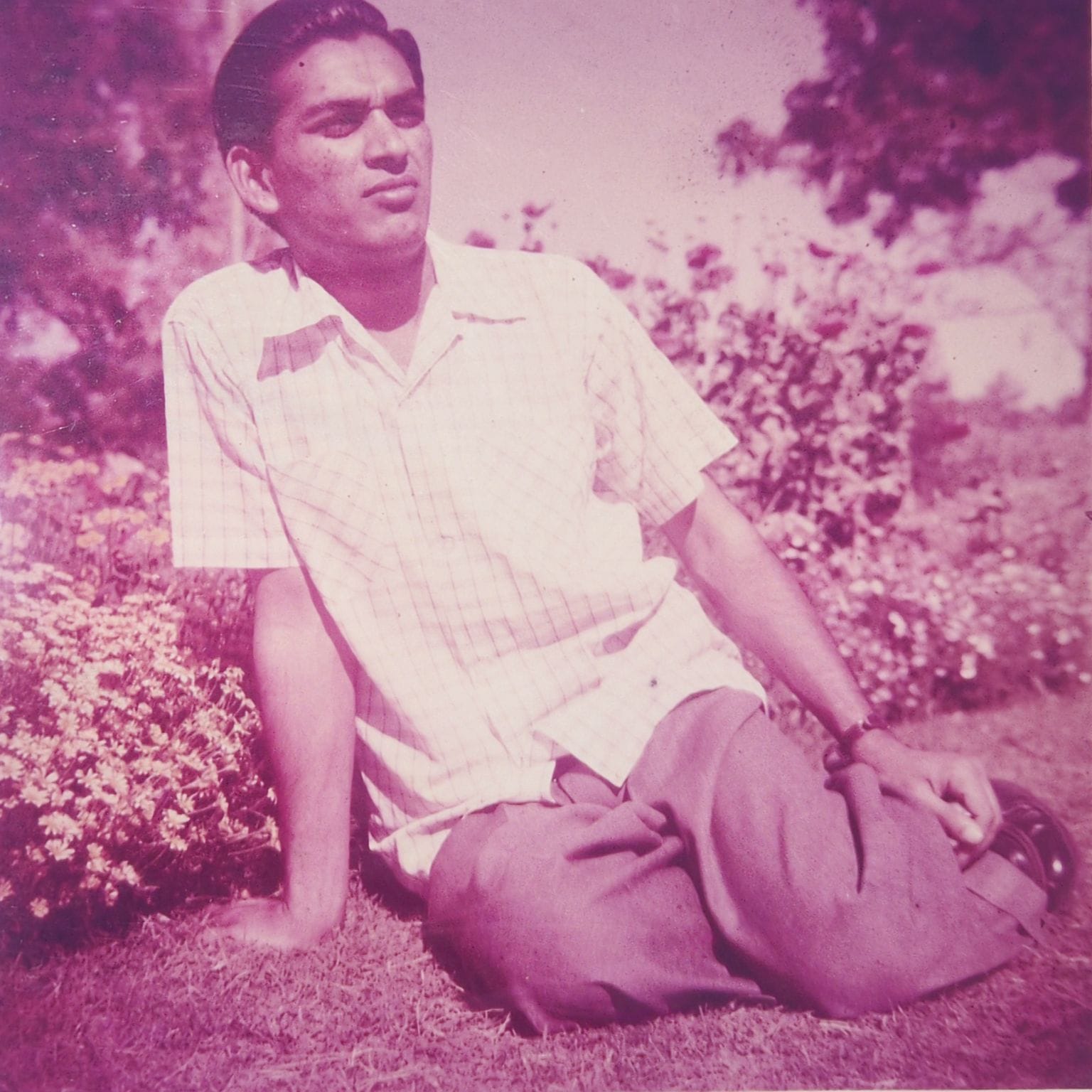 Ram Prashad Gupta as a young man in a flower garden in India, 1950s